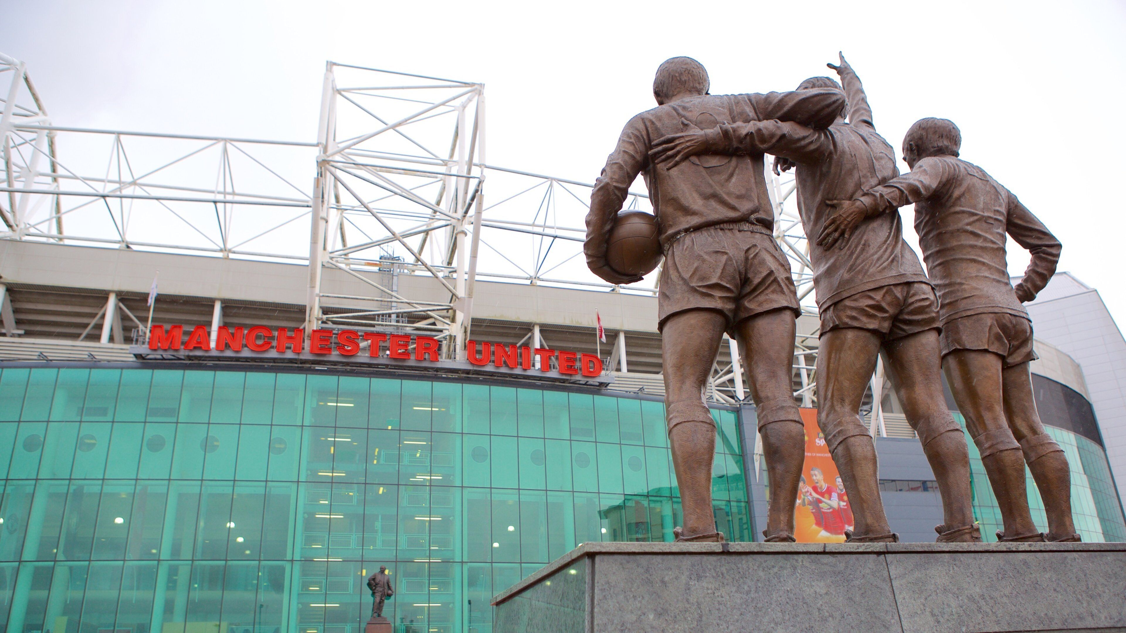 Old Trafford which includes a statue or sculpture