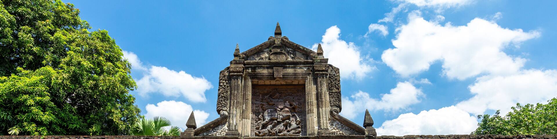 An ancient stone gateway with intricate carvings and a central archway.