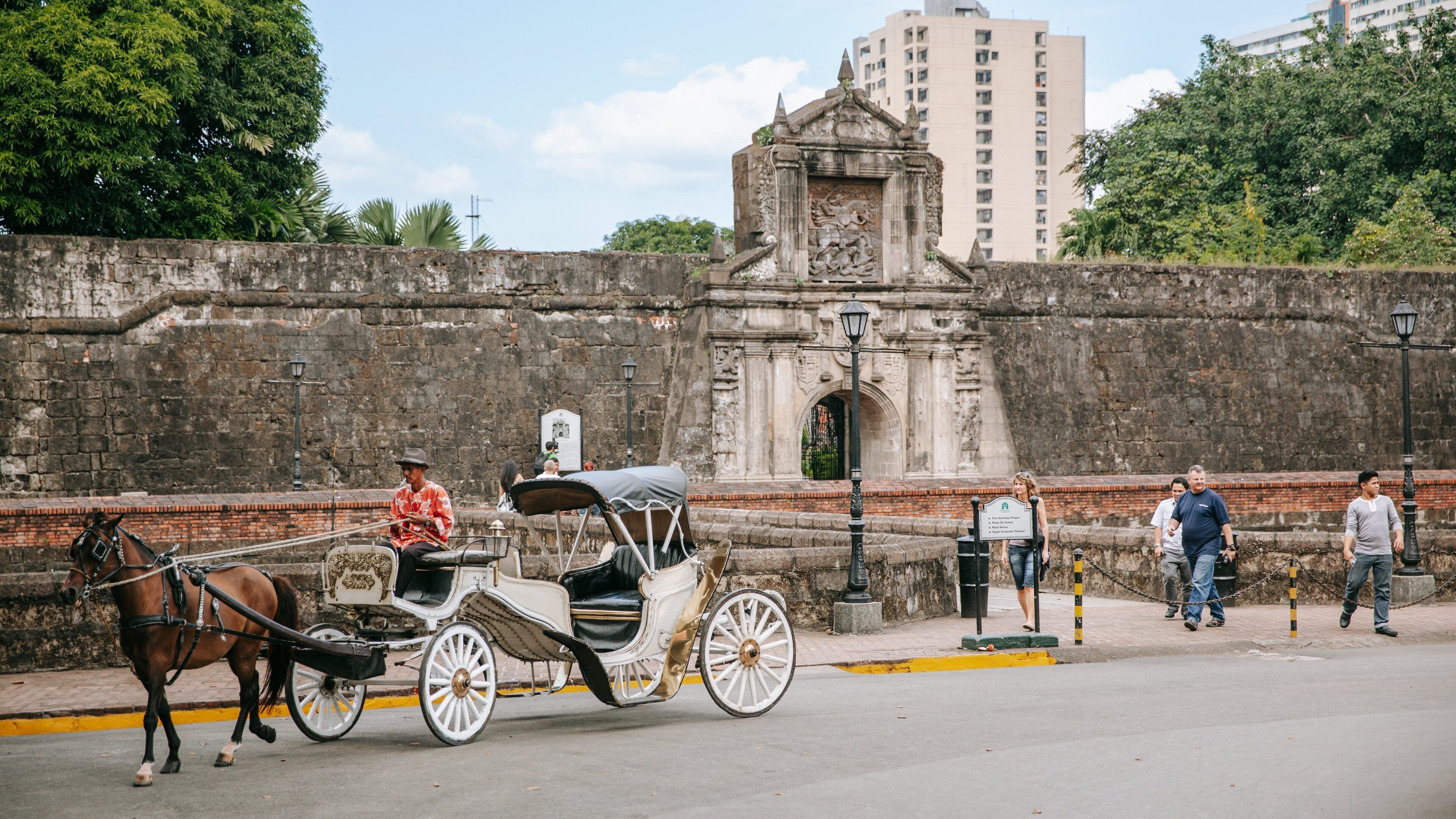 Fort Santiago showing heritage architecture, land animals and horseriding