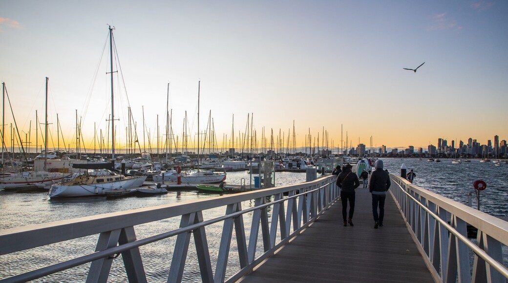 St Kilda Pier featuring a sunset and a bay or harbor as well as a couple
