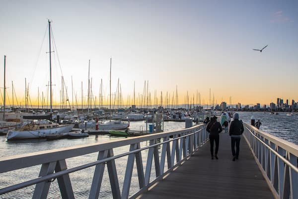 St Kilda Pier featuring a sunset and a bay or harbor as well as a couple