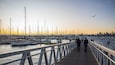 St Kilda Pier featuring a sunset and a bay or harbor as well as a couple