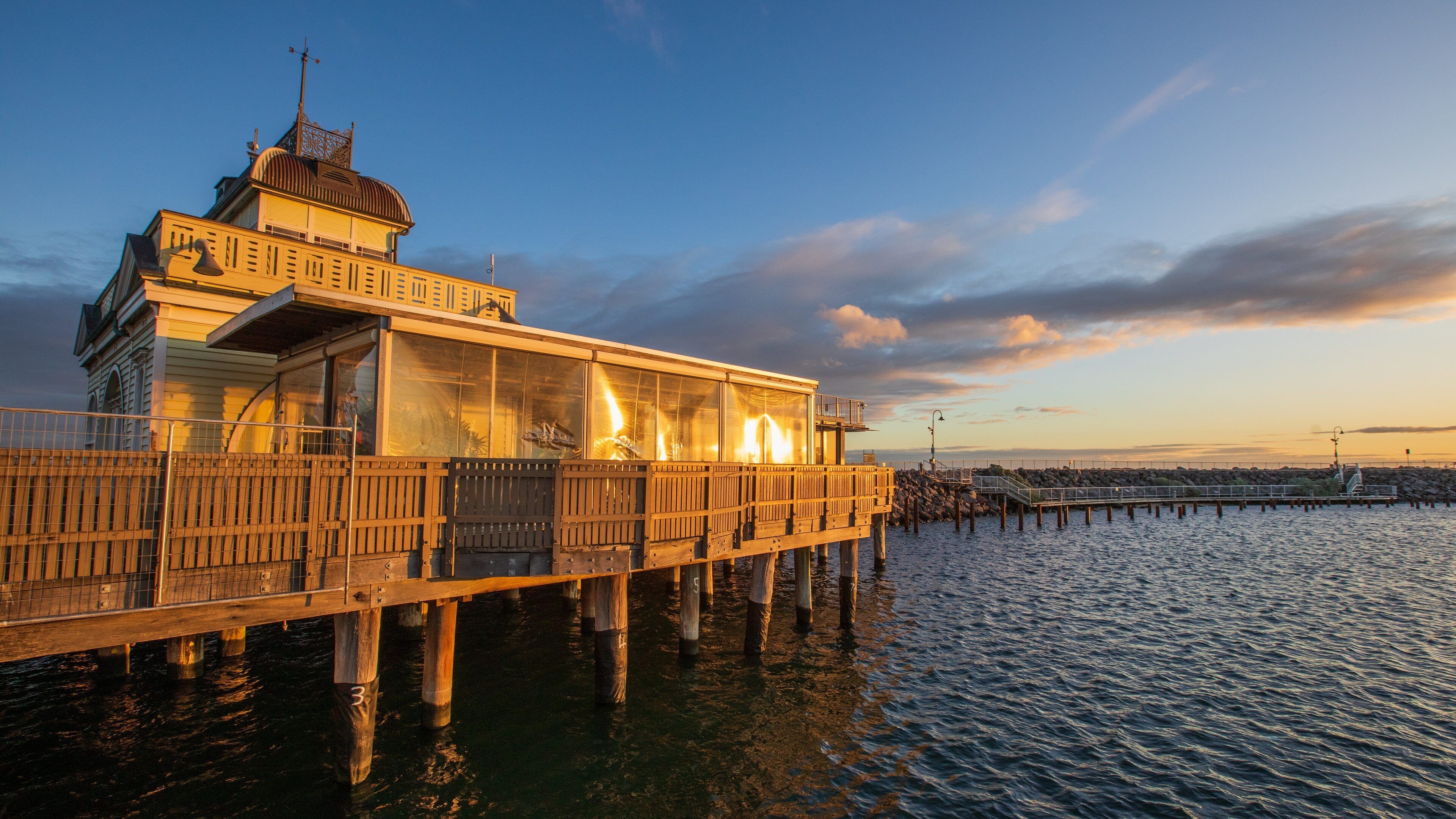 St Kilda Pier featuring a sunset and a bay or harbor