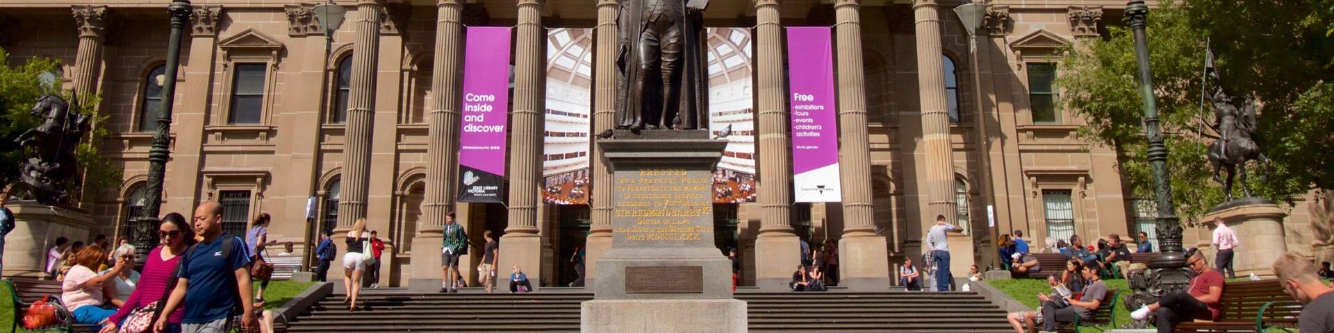 State Library of Victoria showing a city, a statue or sculpture and an administrative buidling