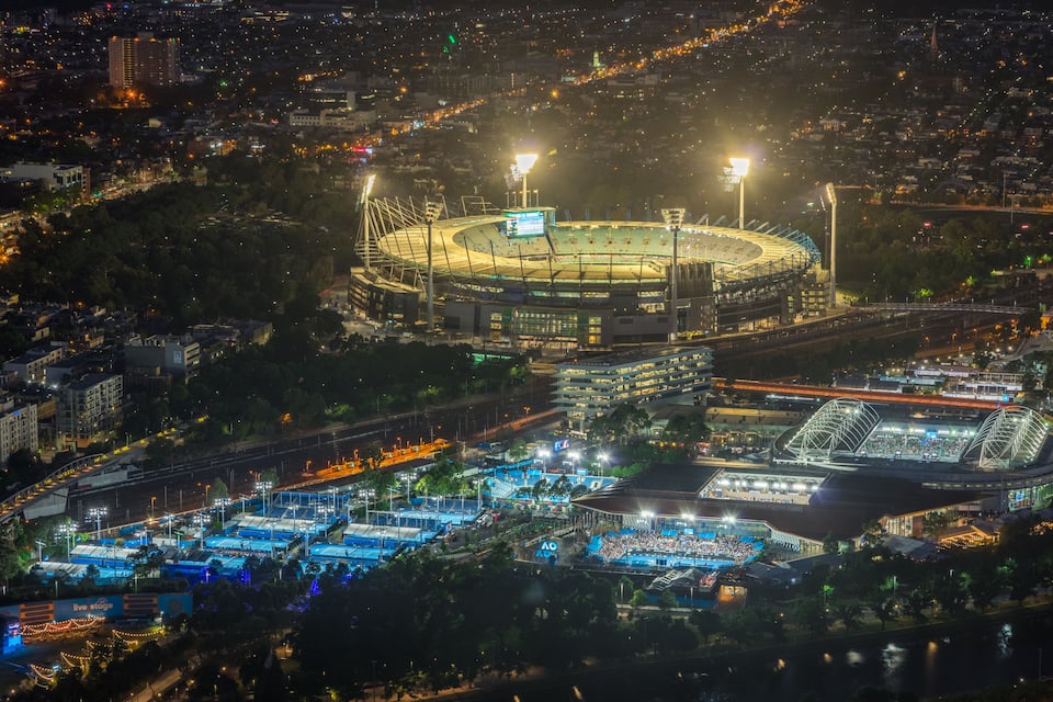Um estádio grande rodeado por edifícios urbanos e um rio.