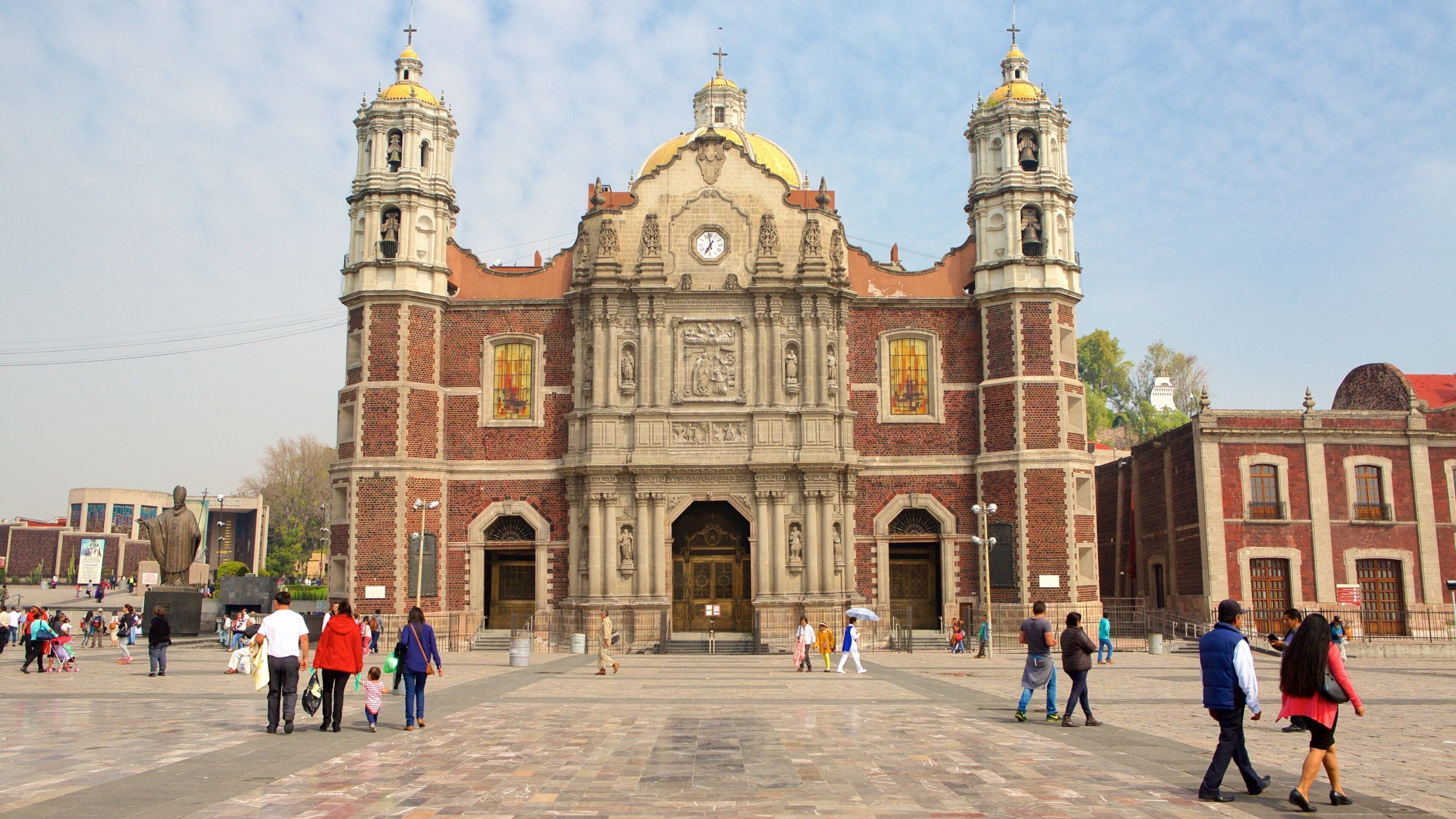 Basilica of Our Lady of Guadalupe which includes a square or plaza, a church or cathedral and heritage architecture