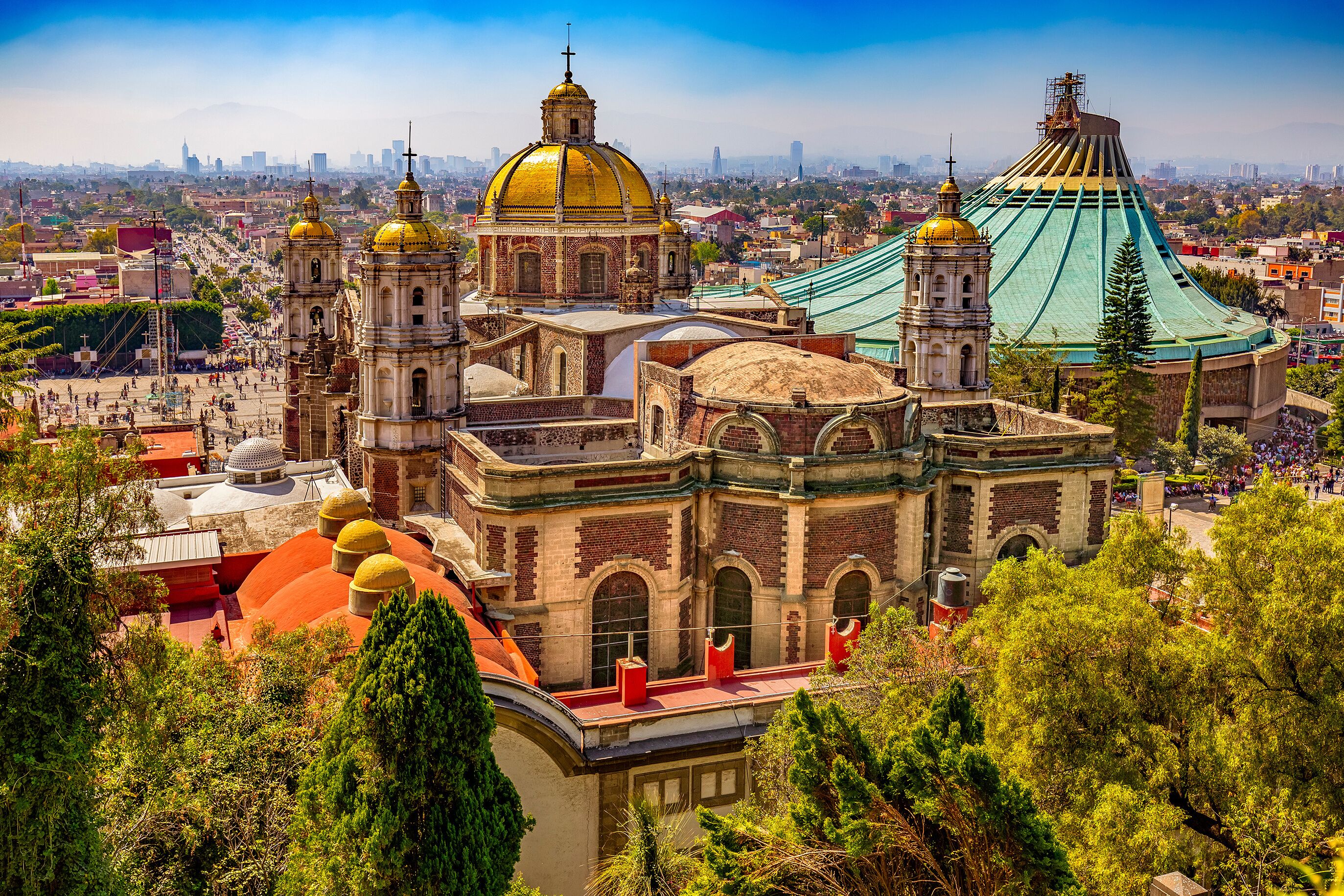 Mexico. Basilica of Our Lady of Guadalupe. The old and the new basilica, cityscape of Mexico City on the far