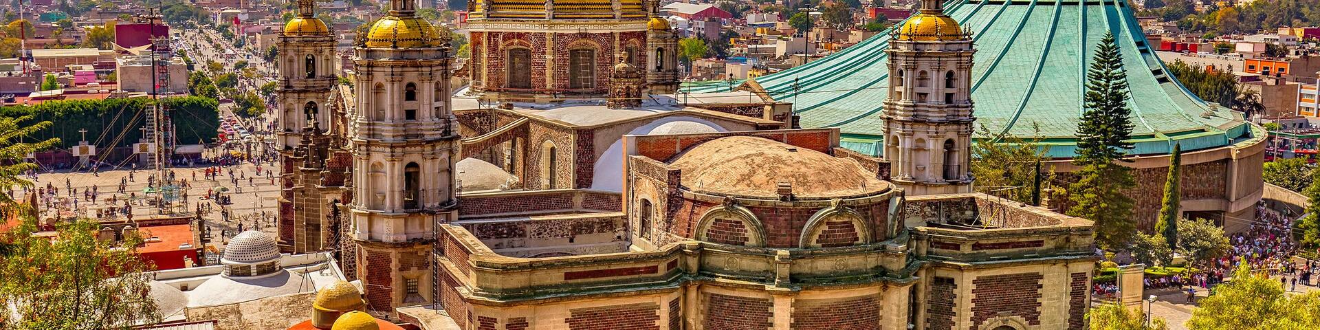 Mexico. Basilica of Our Lady of Guadalupe. The old and the new basilica, cityscape of Mexico City on the far