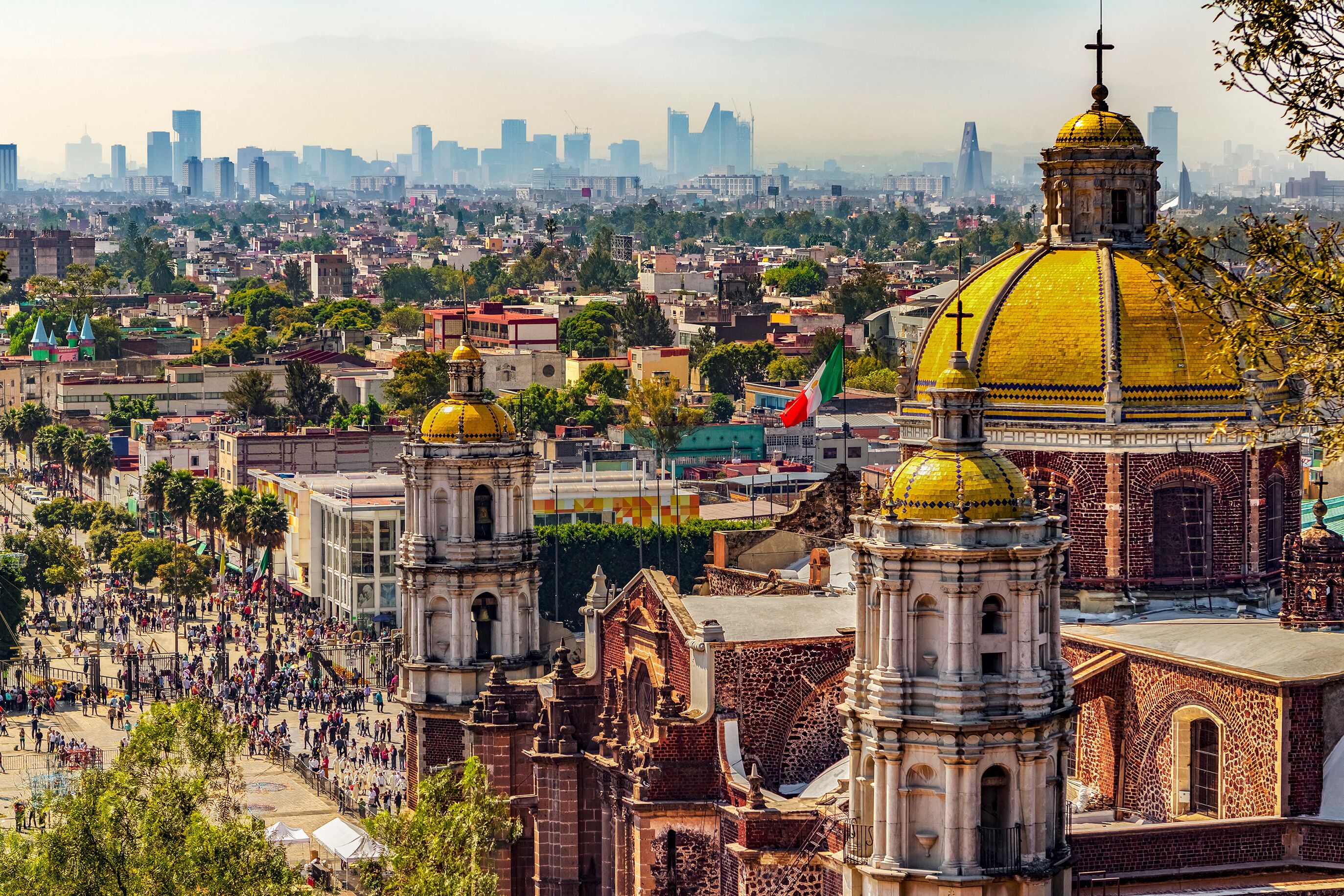 Mexico. Basilica of Our Lady of Guadalupe. The old basilica and cityscape of Mexico City on the far