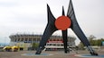 Estadio Azteca featuring a statue or sculpture and a square or plaza