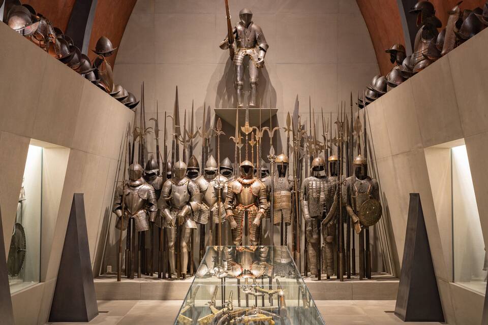 A museum exhibit with medieval armor and weapons.