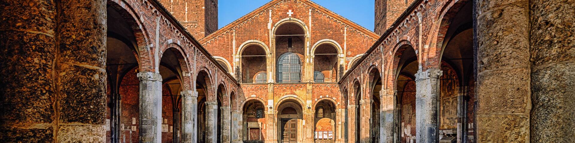 A historic building with a central courtyard, tall towers, and arched walkways.