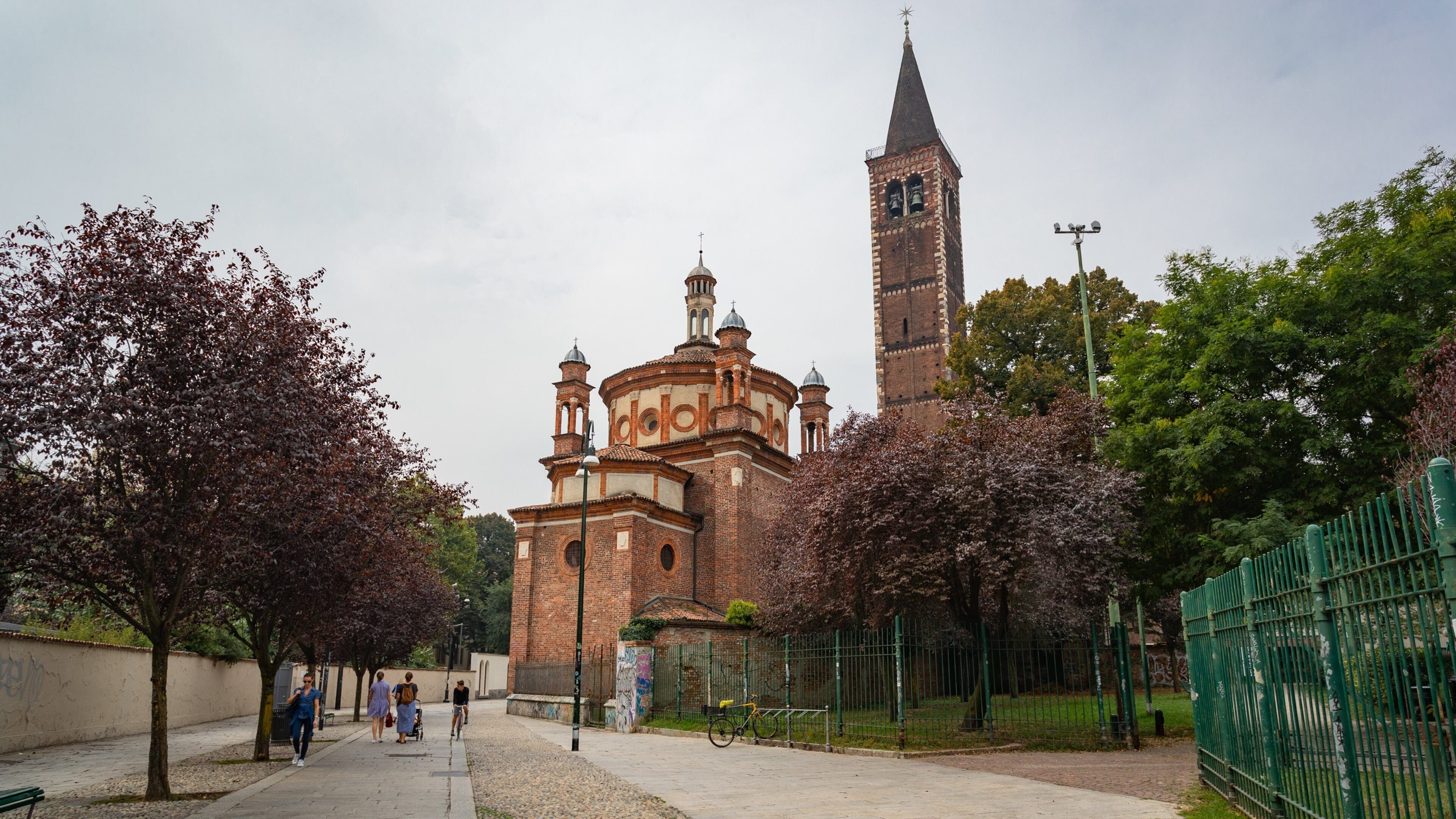 A historic church with a tall bell tower and a smaller dome structure.