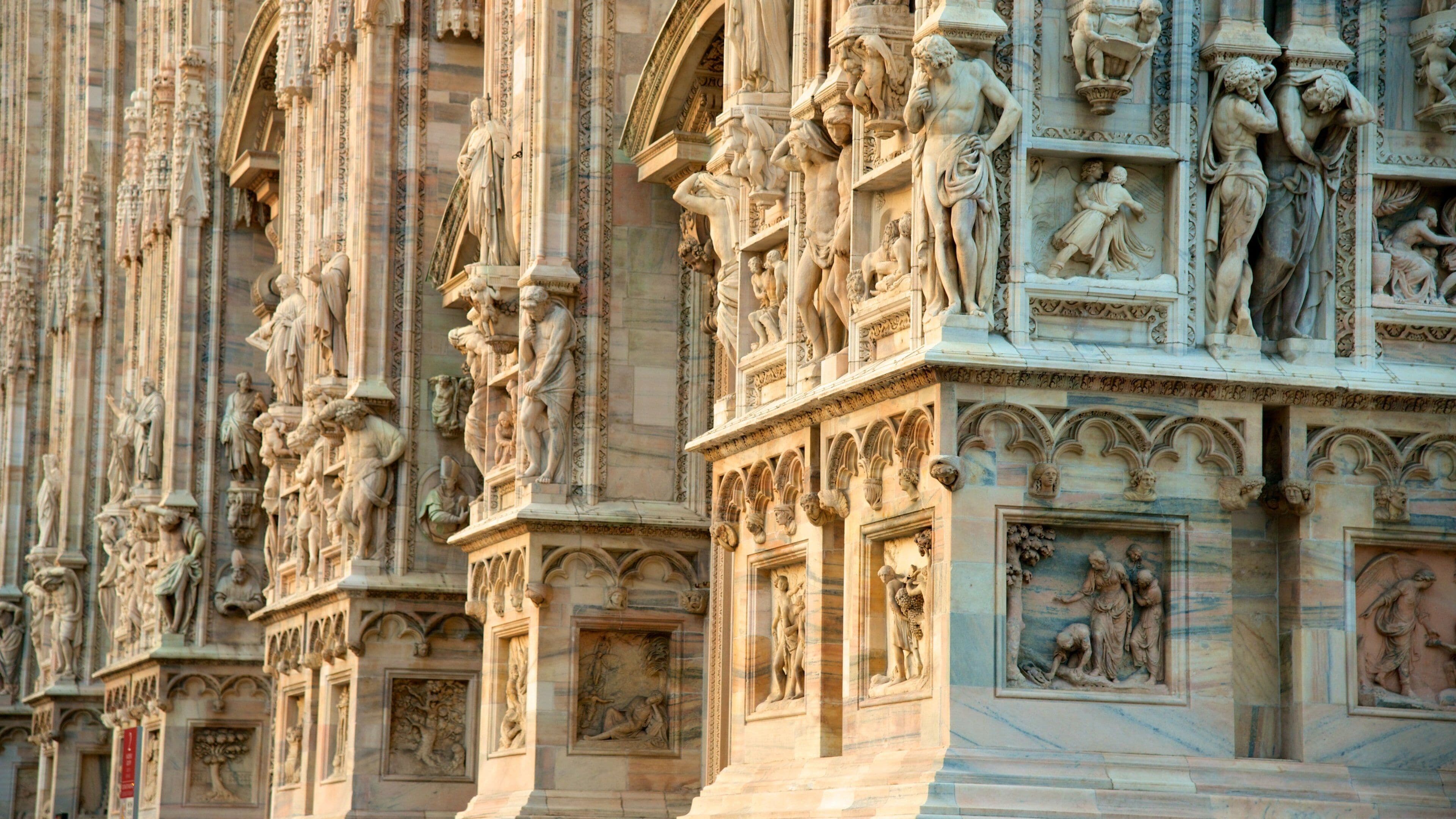 Cathedral of Milan which includes a statue or sculpture, a church or cathedral and heritage architecture