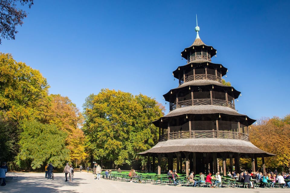 A pagoda-style pavilion surrounded by autumn trees in a park.