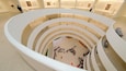 A modern art museum with multiple levels and a central open space.