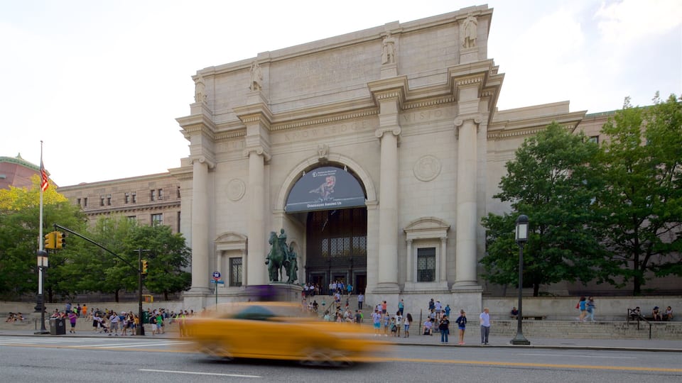 A large neoclassical building with a prominent archway and a statue above it.