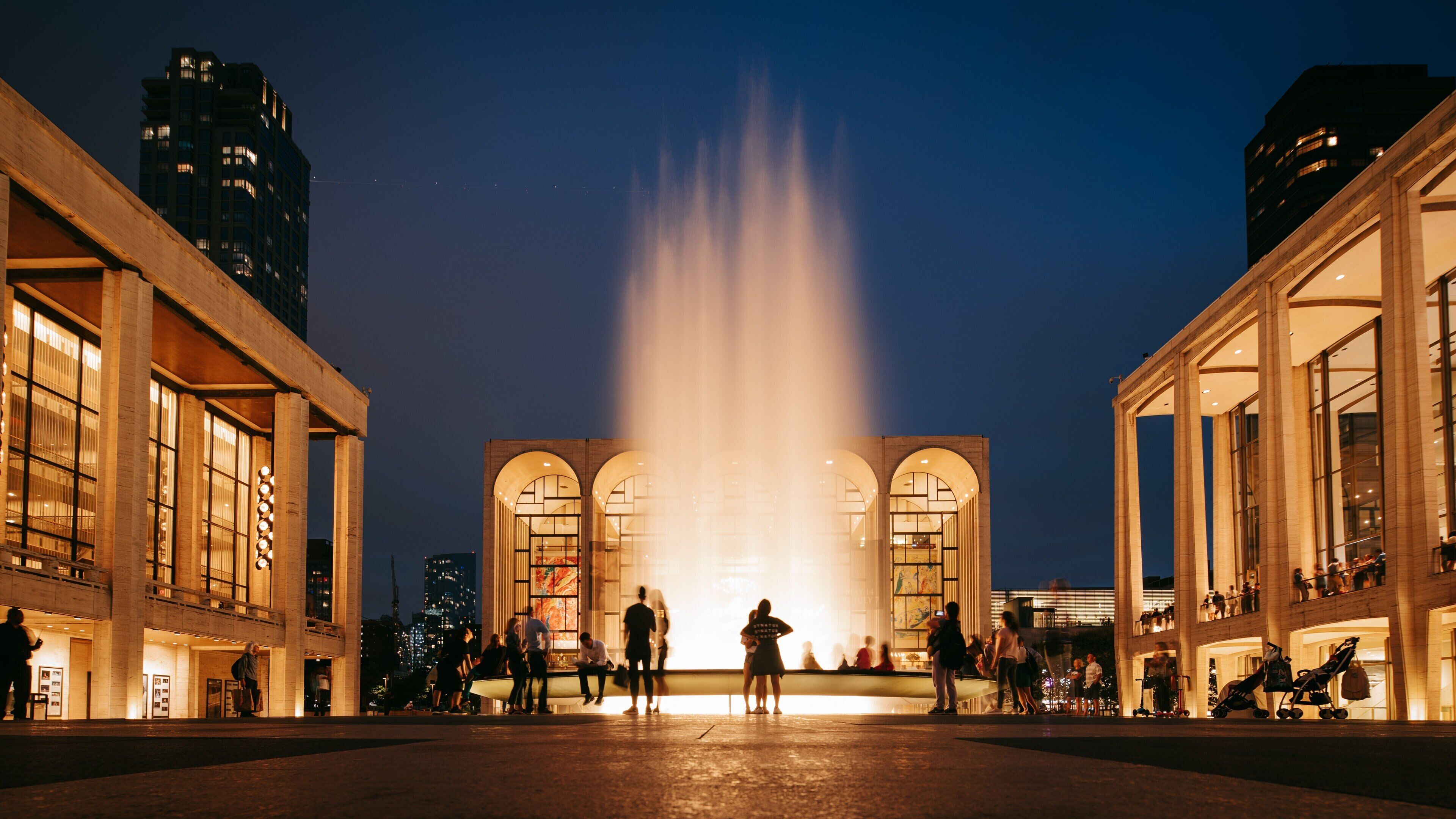 Lincoln Center featuring street scenes, night scenes and a fountain
