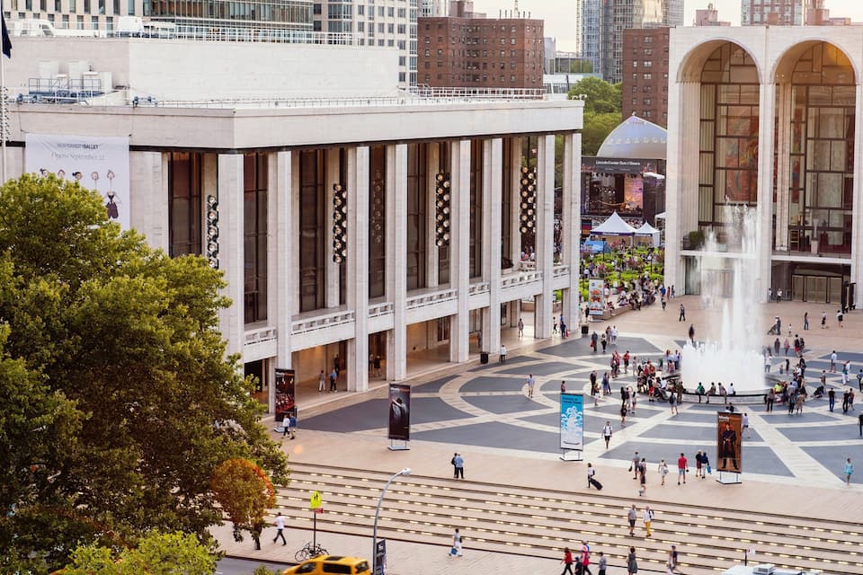 A public square with a fountain, a large building with columns, and a Lincoln Center entrance.