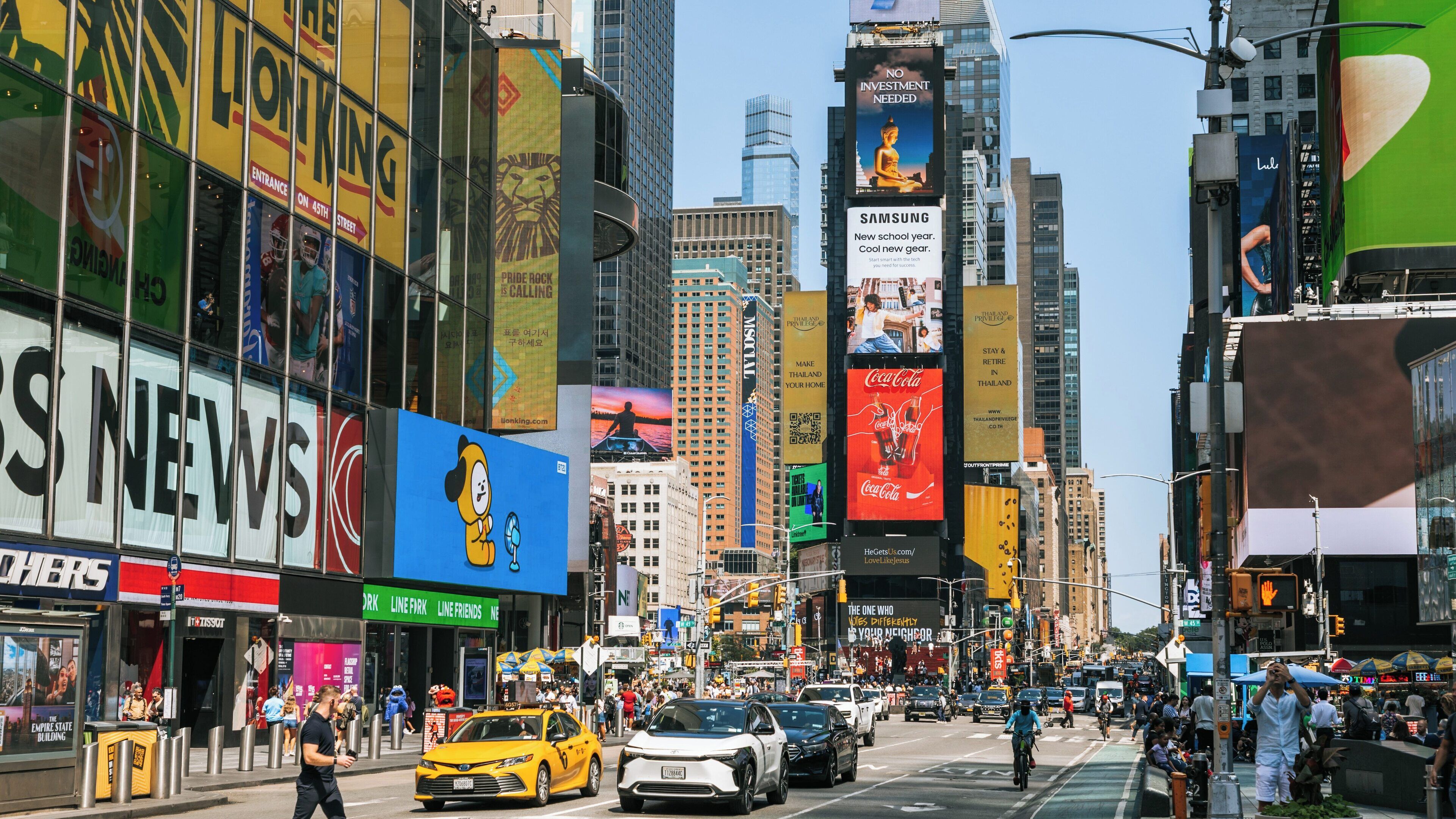 Vibrant day in Times Square Manhattan shining with bright billboards and bustling traffic in the heart of New York City