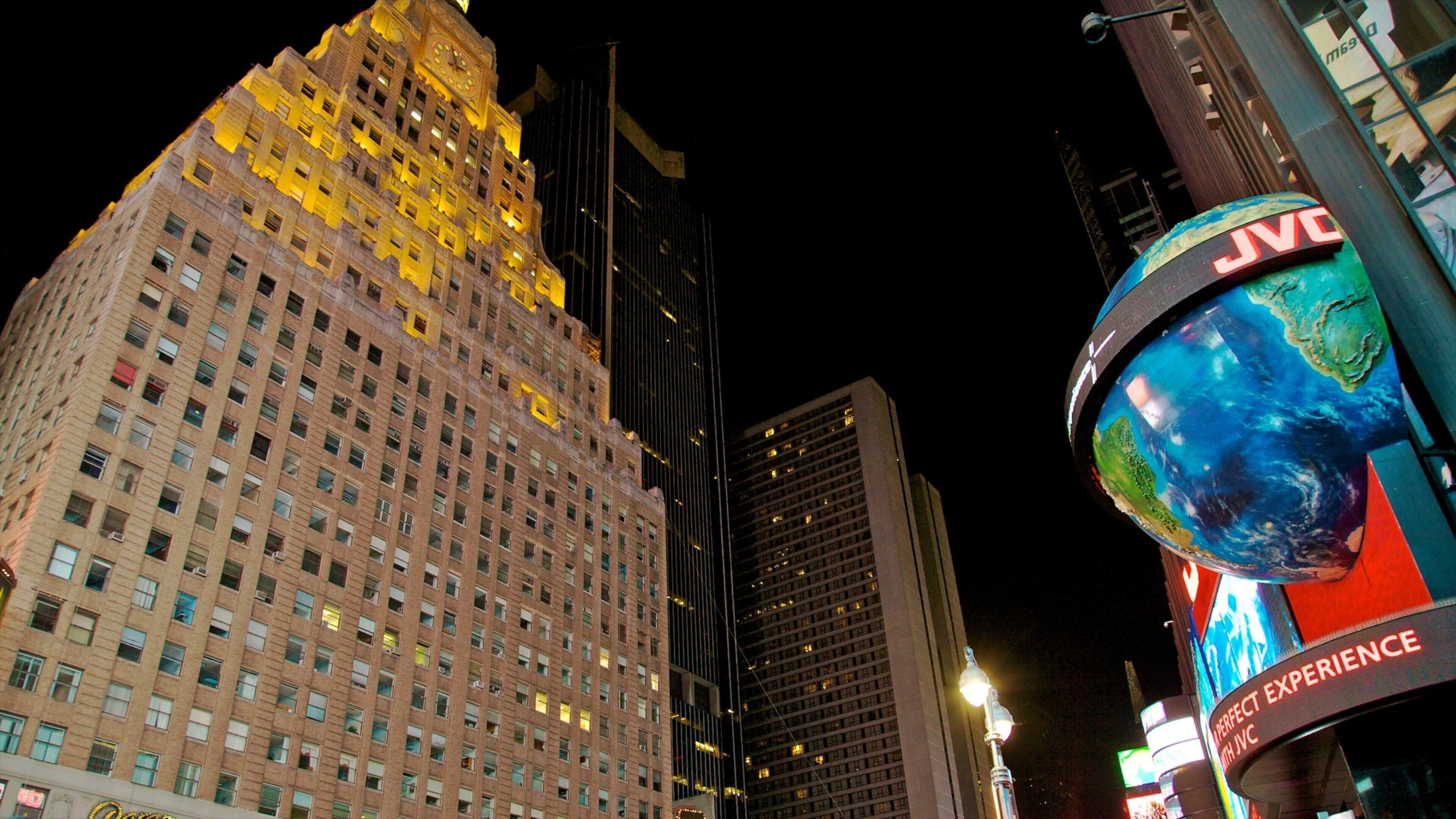 Vibrant lights illuminate Times Square at night in New York City, showcasing bustling activity and iconic architecture