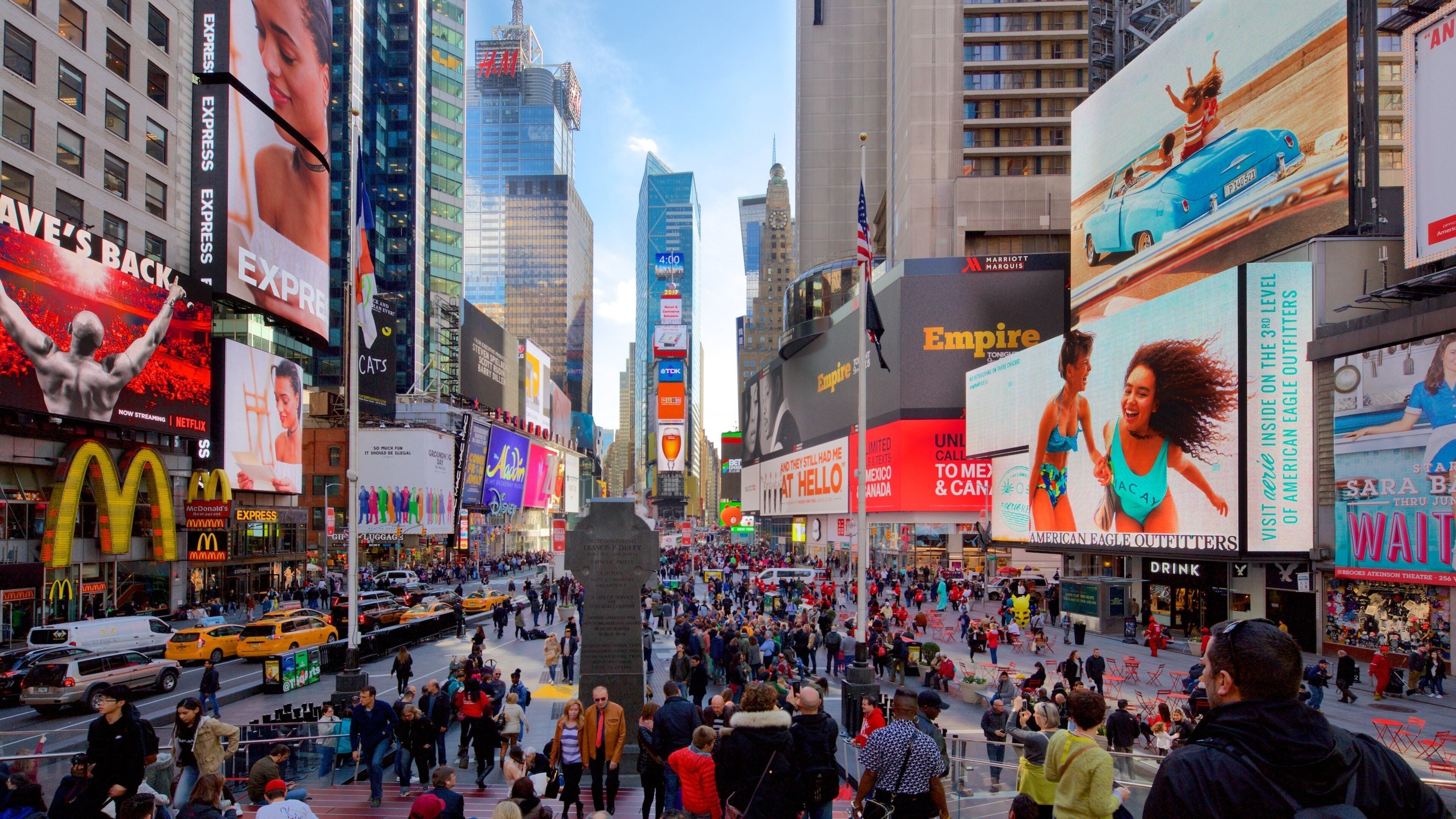Times Square which includes a skyscraper, a city and signage
