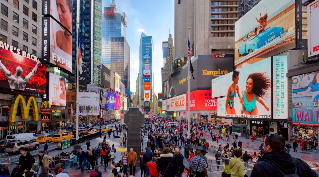 Times Square which includes a skyscraper, a city and signage
