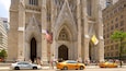 A historic building with intricate Gothic architecture, featuring pointed arches and detailed stone carvings.