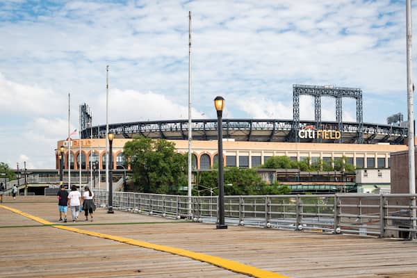 Citi Field featuring street scenes as well as a small group of people