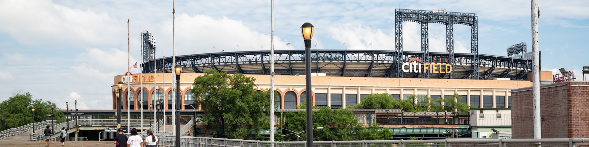 Citi Field featuring street scenes as well as a small group of people