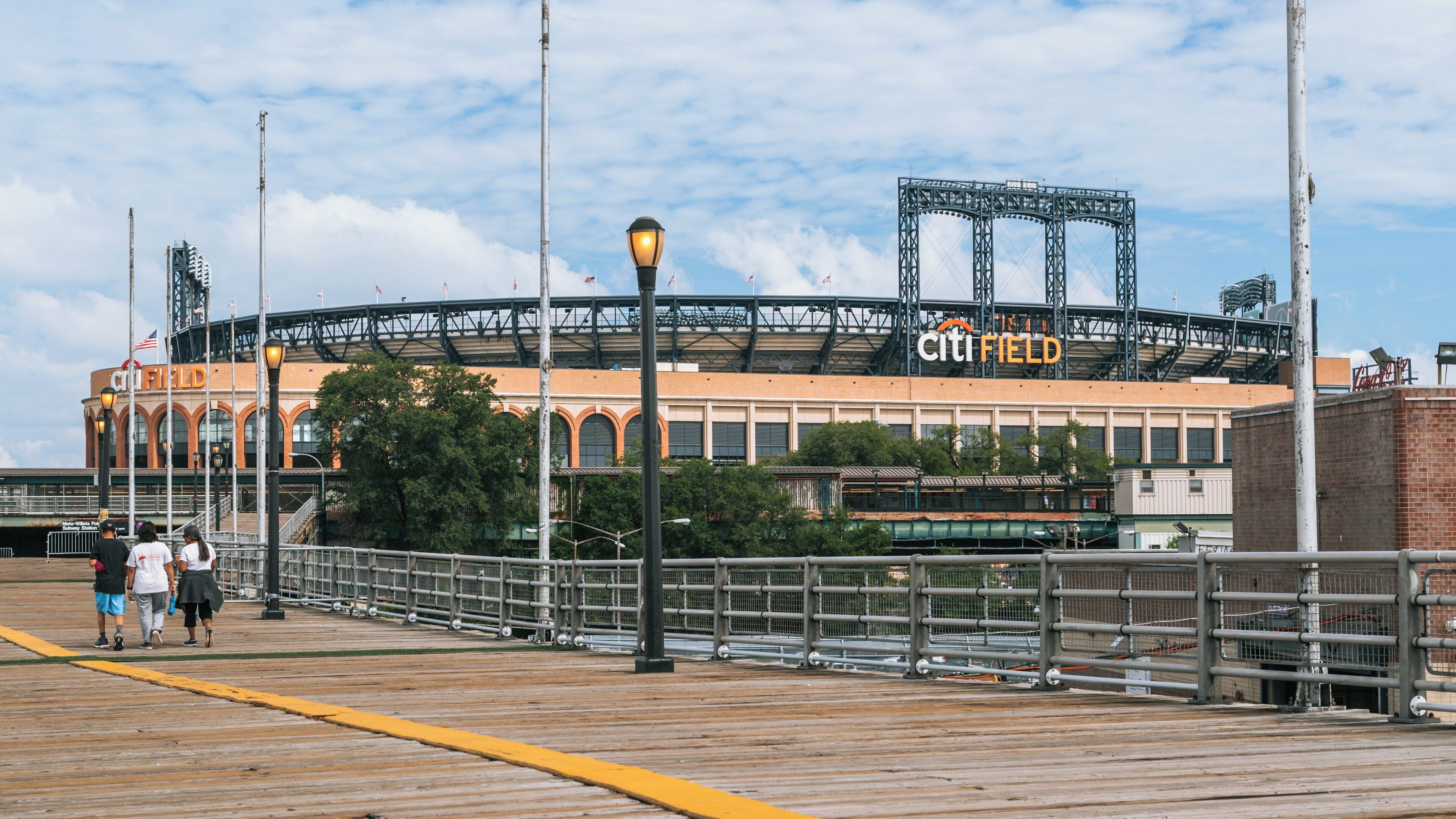 Citi Field in Queens offers a vibrant sports atmosphere with fans enjoying the day in the iconic ballpark setting