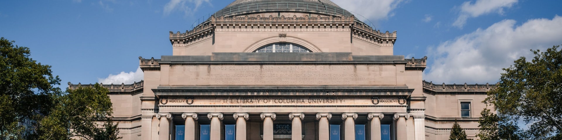 The exterior of The Library of Columbia University with a dome and columns.
