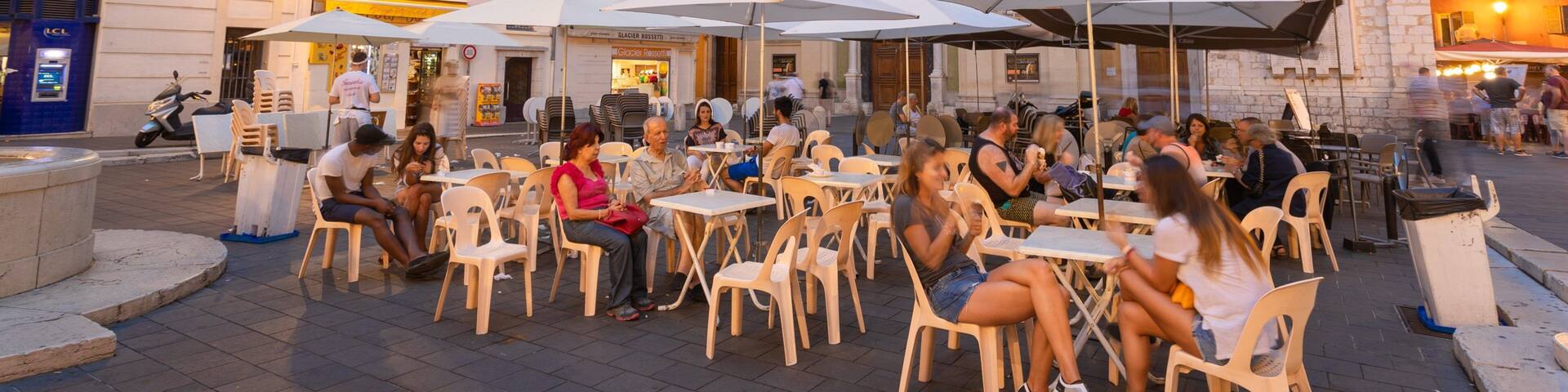 Nice Cathedral showing a city and outdoor eating as well as a small group of people