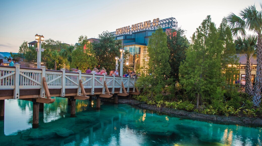 Disney Springs® showing a river or creek, a bridge and a sunset