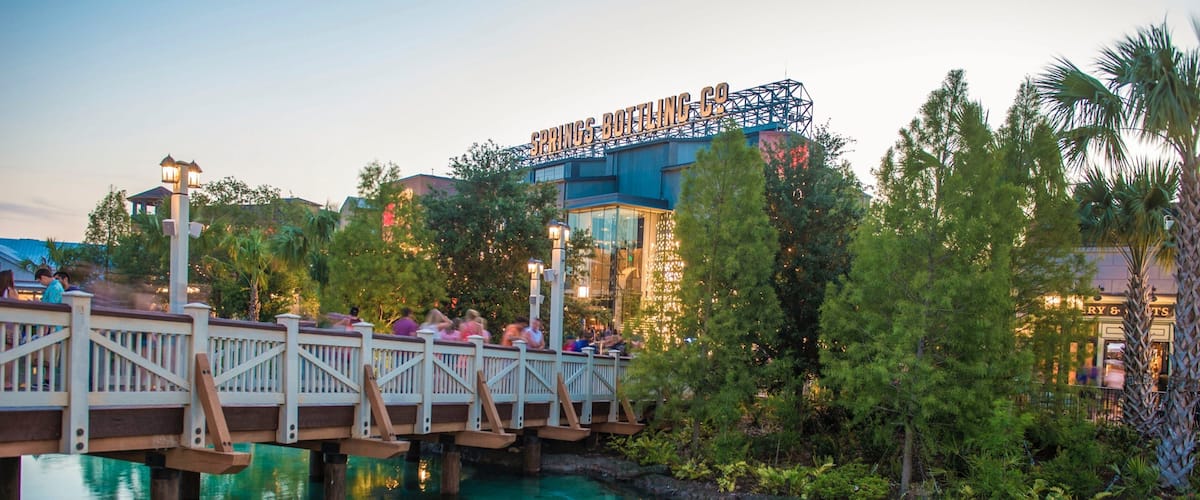 Disney Springs® showing a river or creek, a bridge and a sunset