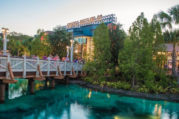 Disney Springs® showing a river or creek, a bridge and a sunset
