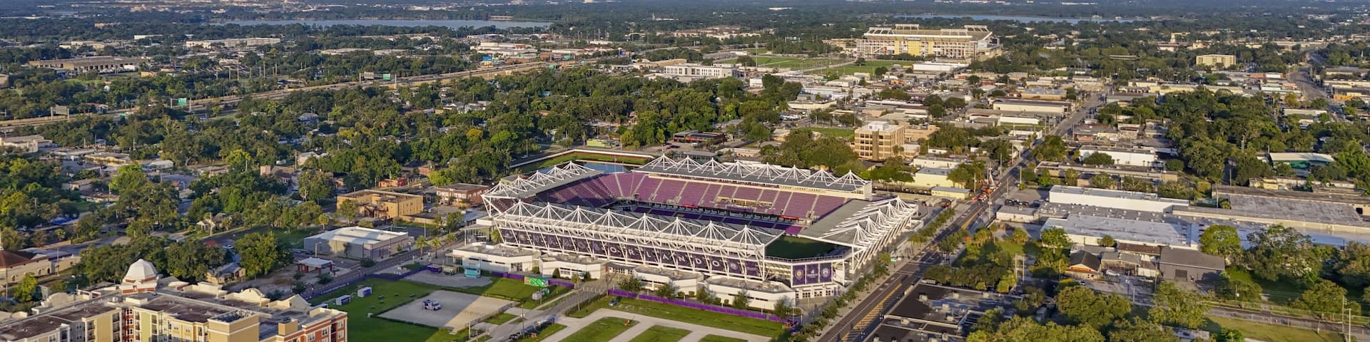 A stadium surrounded by urban buildings and greenery.