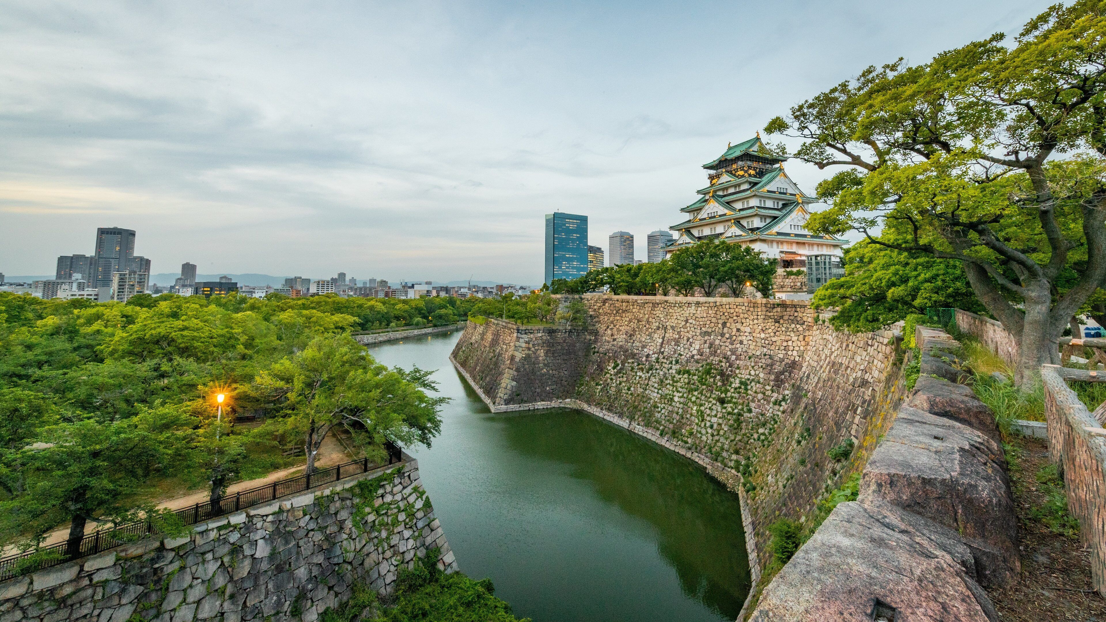 Osaka Castle showing heritage elements and a river or creek
