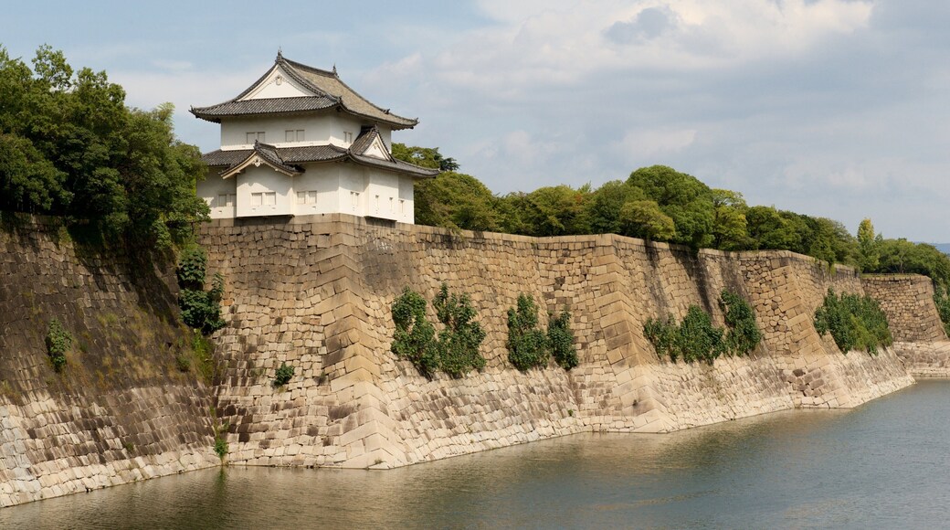 Osaka Castle featuring a lake or waterhole and heritage elements