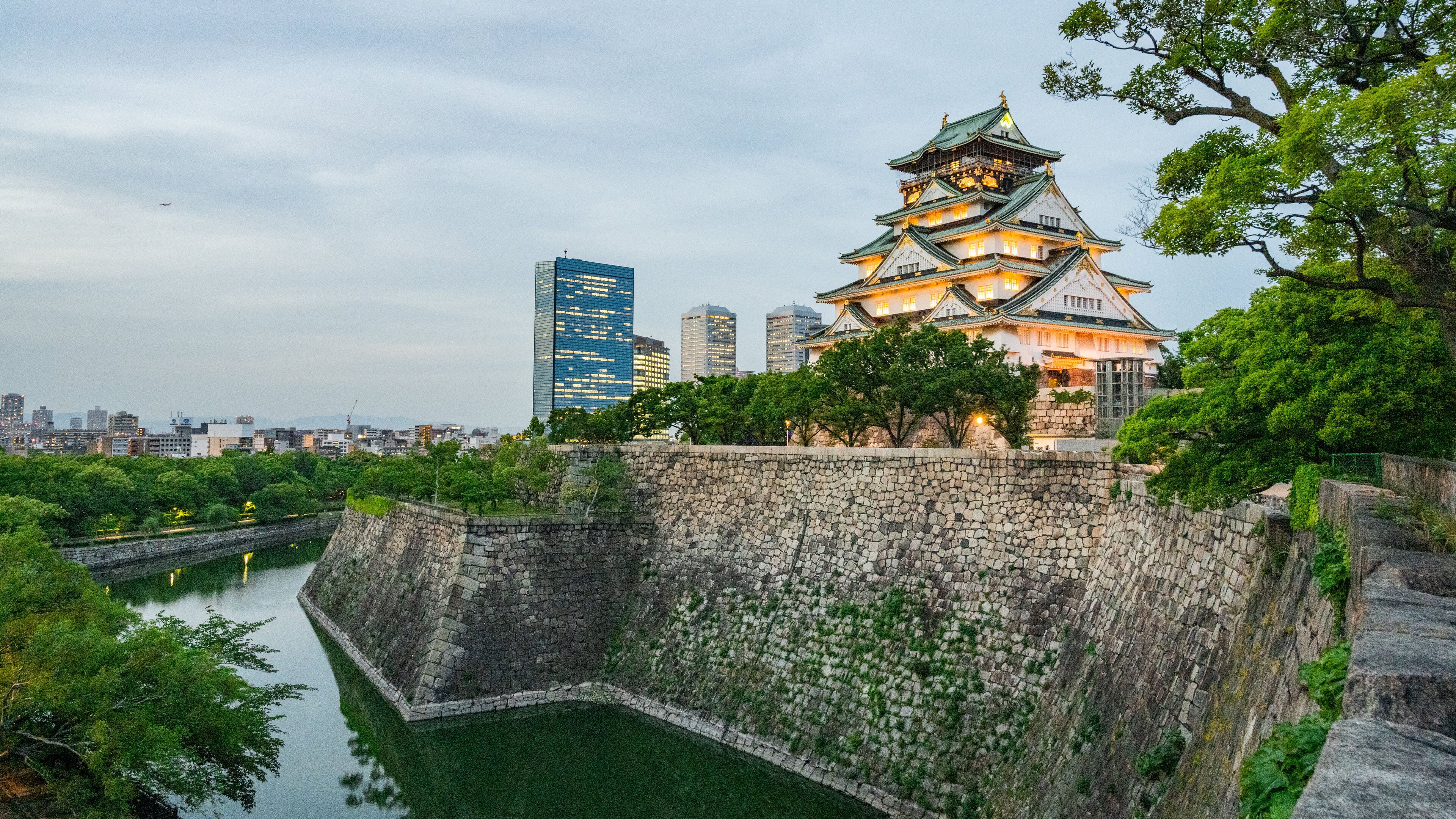 Osaka Castle which includes night scenes, a river or creek and heritage architecture