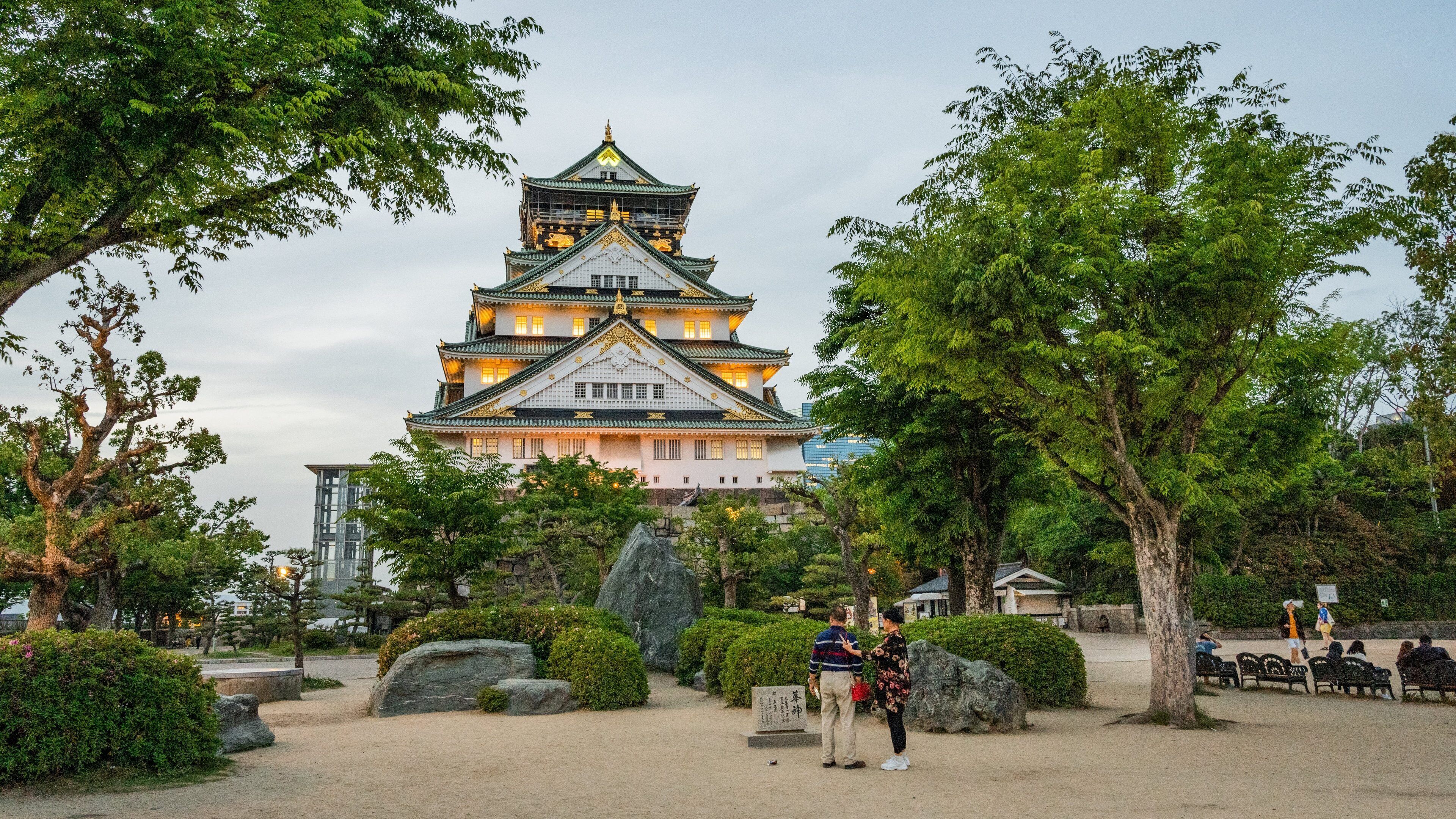 Osaka Castle showing heritage architecture as well as a couple