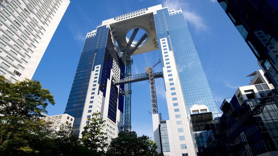 A modern skyscraper with a circular atrium and a prominent steel structure.