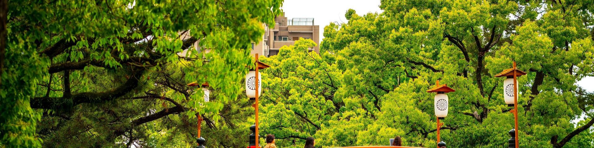 Sumiyoshi Taisha Shrine featuring a bridge as well as a small group of people