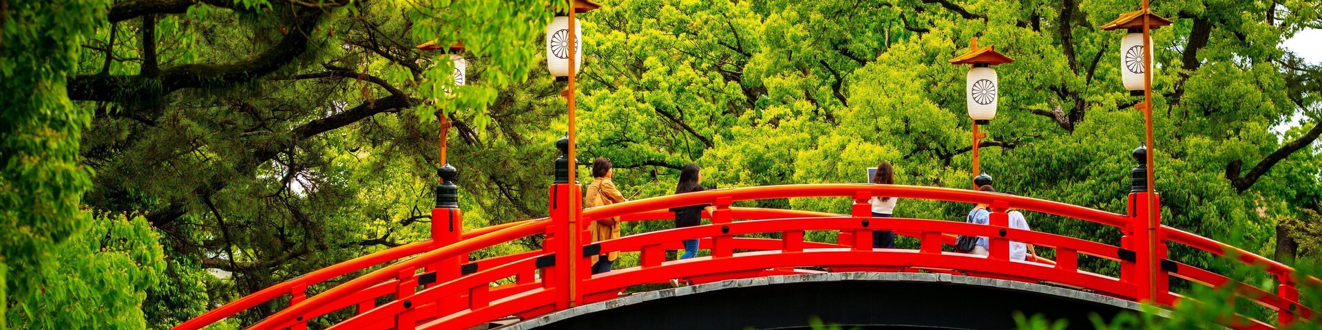 Sumiyoshi Taisha Shrine featuring a bridge as well as a small group of people