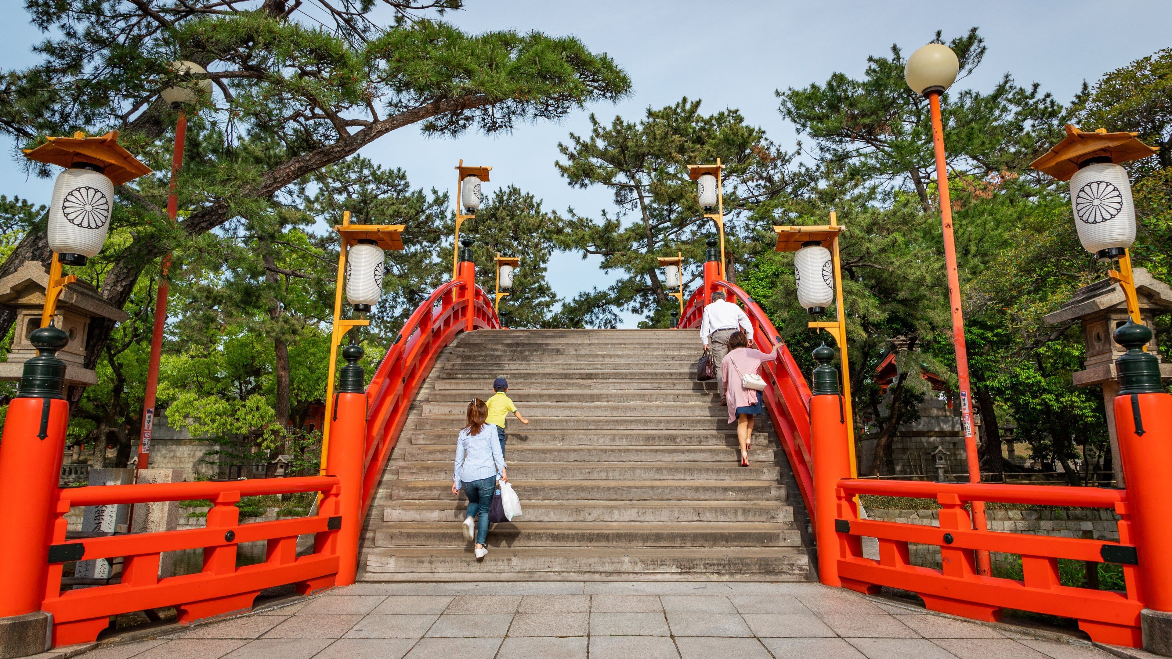 Sumiyoshi Taisha Shrine showing a bridge as well as a small group of people
