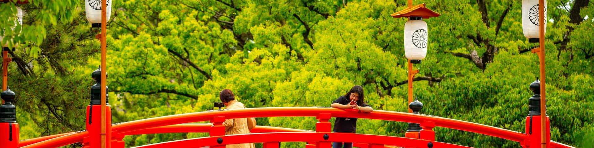 Sumiyoshi Taisha Shrine showing a bridge as well as an individual femail