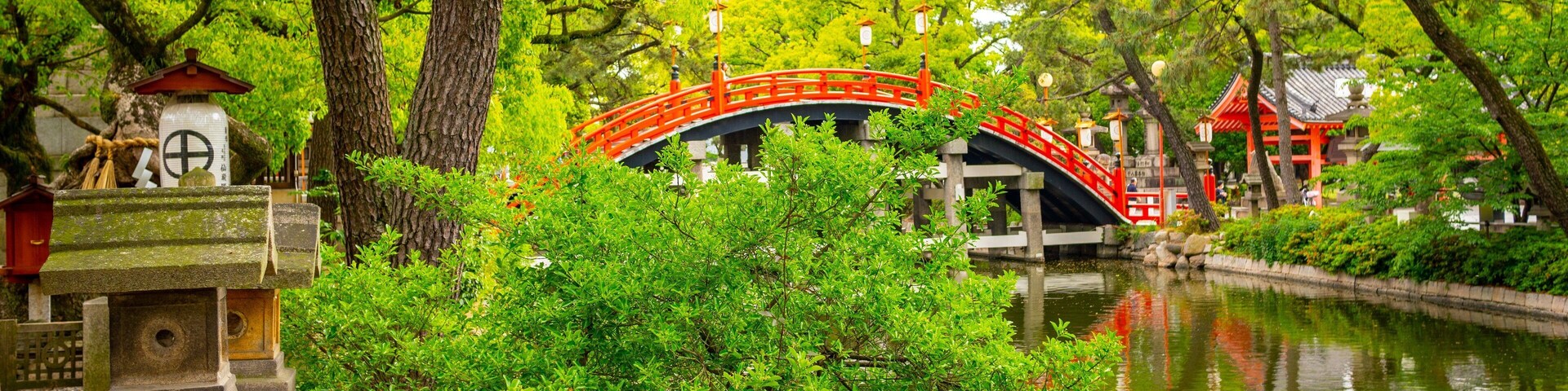 Sumiyoshi Taisha Shrine which includes a bridge and a river or creek