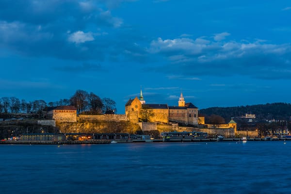 Akershus Fortress at the blue hour. View from the Aker Brygge Marina. Oslo, Norway.