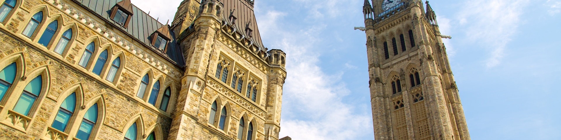 A historic building with a clock tower and arched windows.