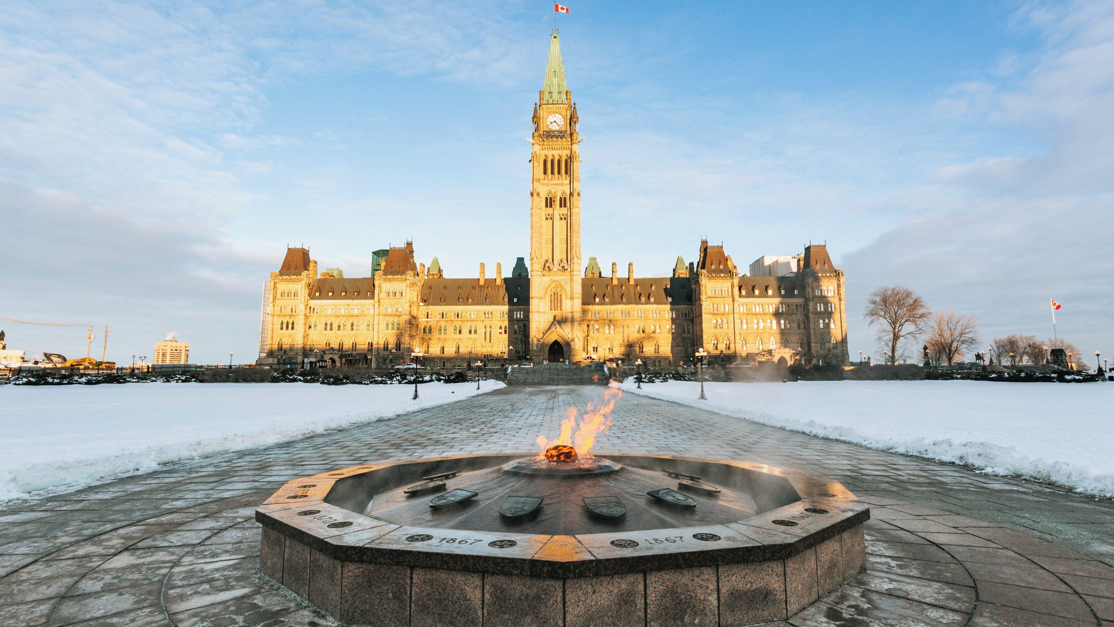Historic Parliament Hill during winter in Downtown Ottawa, Ontario showcasing the Centennial Flame and snow-covered grounds